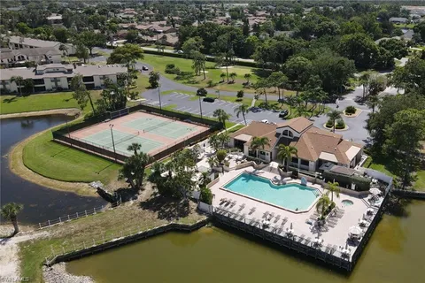 an aerial view of a house with a garden and lake view