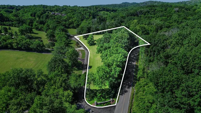 an aerial view of residential houses with outdoor green space