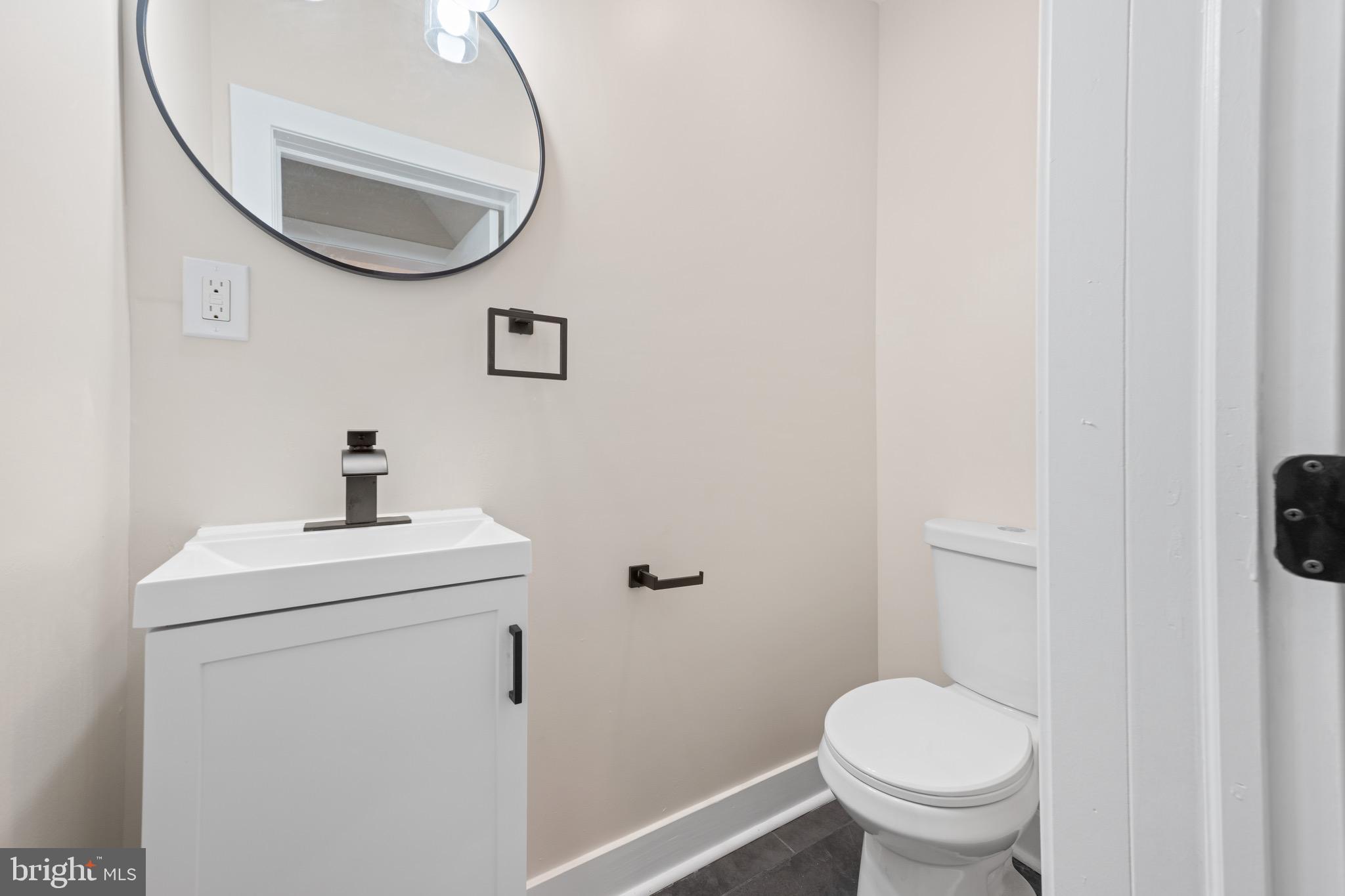 261 B Street Carneys Point, NJ 08069 - Photo 12 of 32 a bathroom with a sink a toilet and a mirror