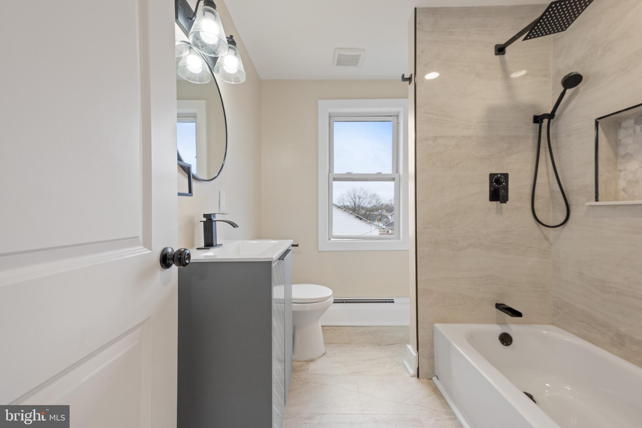 261 B Street Carneys Point, NJ 08069 - Photo 21 of 32 a bathroom with a granite countertop sink a toilet and shower