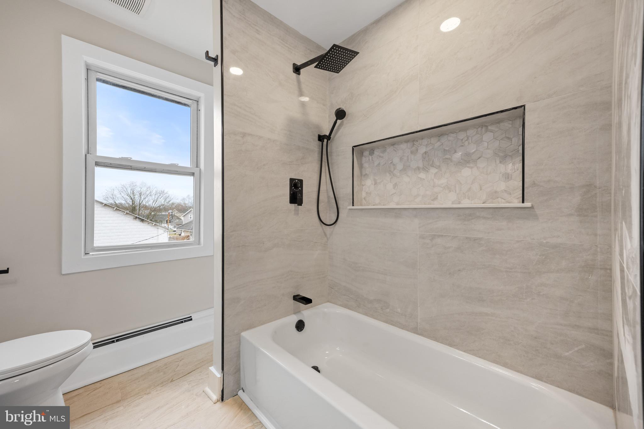 261 B Street Carneys Point, NJ 08069 - Photo 22 of 32 a bathroom with a bathtub and a shower