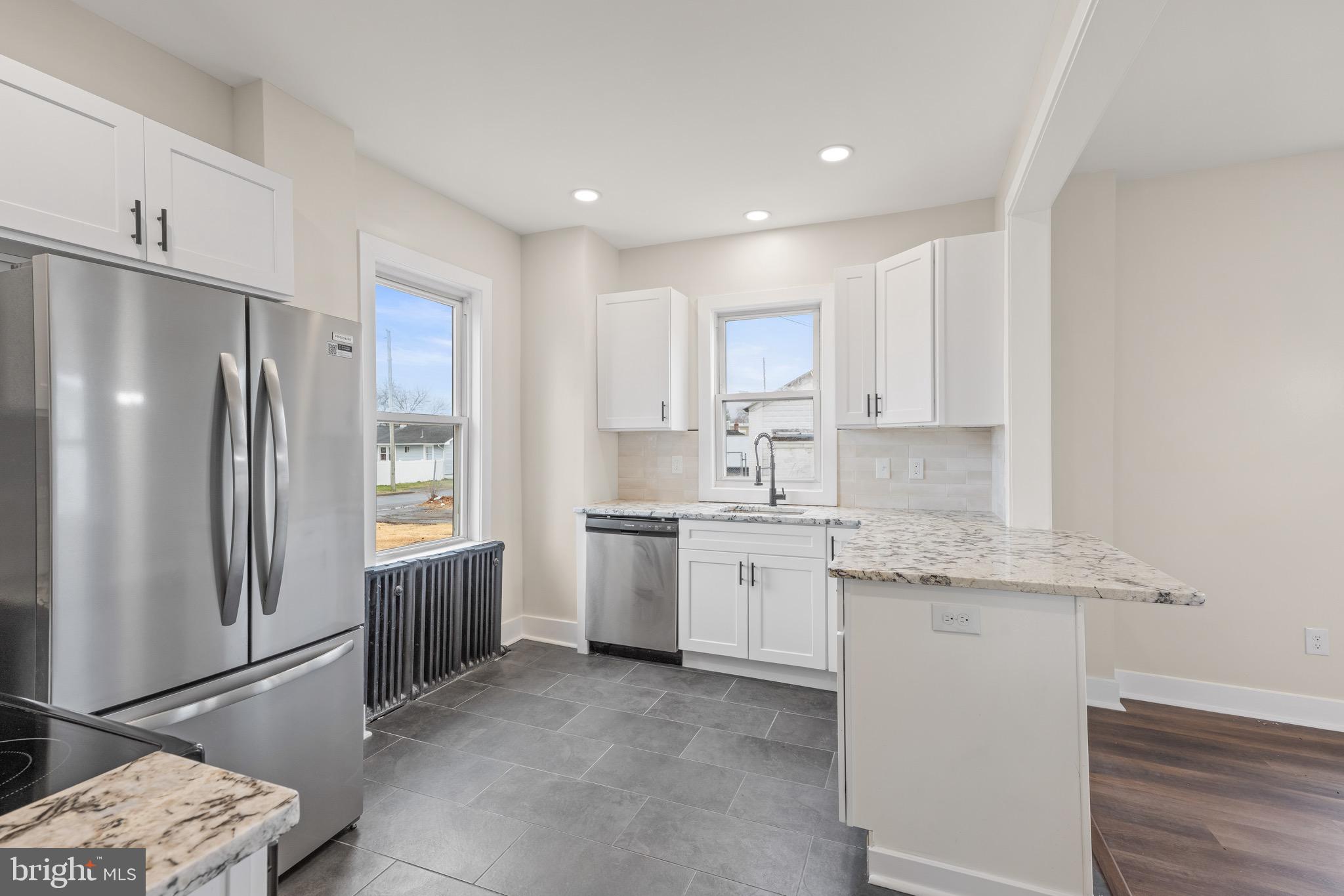 261 B Street Carneys Point, NJ 08069 - Photo 3 of 32 a kitchen with stainless steel appliances granite countertop a refrigerator sink and cabinets