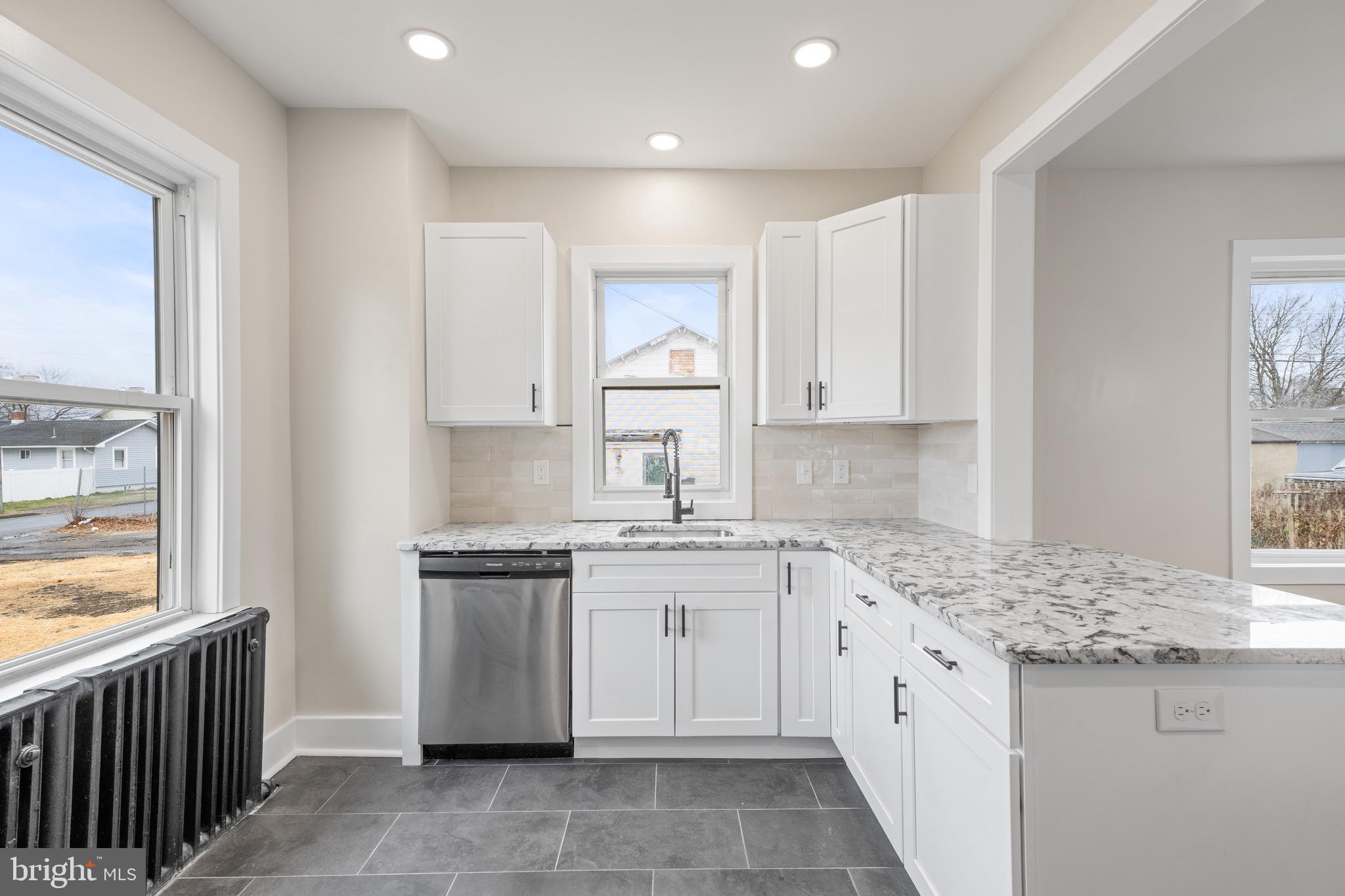 261 B Street Carneys Point, NJ 08069 - Photo 4 of 32 a kitchen that has a sink and a stove