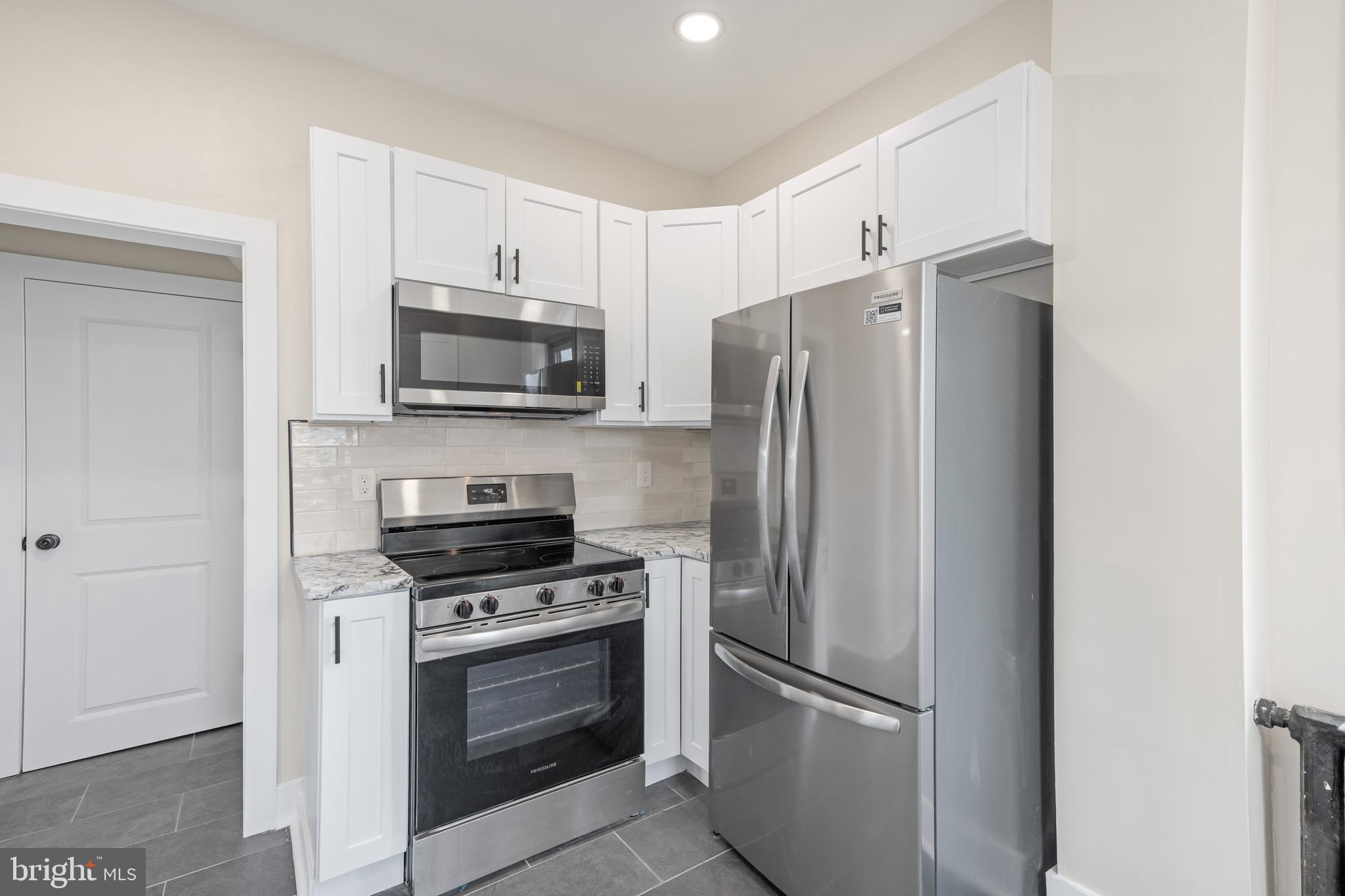 261 B Street Carneys Point, NJ 08069 - Photo 5 of 32 a kitchen with stainless steel appliances a refrigerator stove and microwave