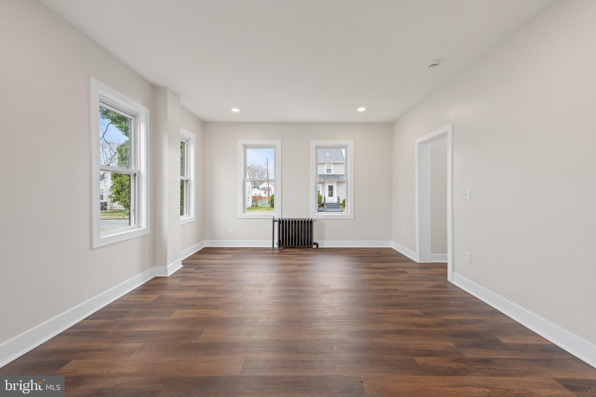 261 B Street Carneys Point, NJ 08069 - Photo 8 of 32 a view of empty room with wooden floor and fan