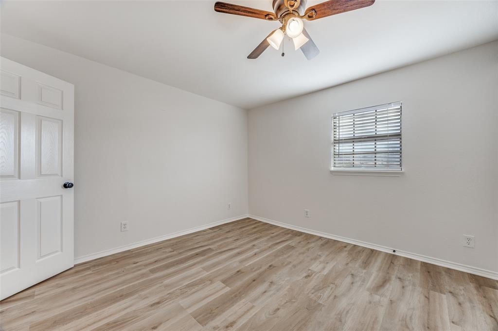 1382 Us Highway Denison, TX 75021 - Photo 14 of 25 wooden floor in an empty room with a window