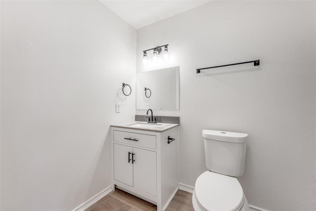 1382 Us Highway Denison, TX 75021 - Photo 19 of 25 a bathroom with a toilet a sink and mirror