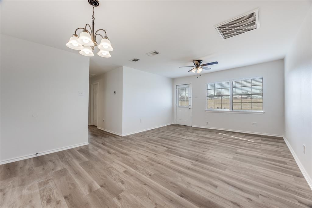 1382 Us Highway Denison, TX 75021 - Photo 4 of 25 a view of an empty room with a window and wooden floor
