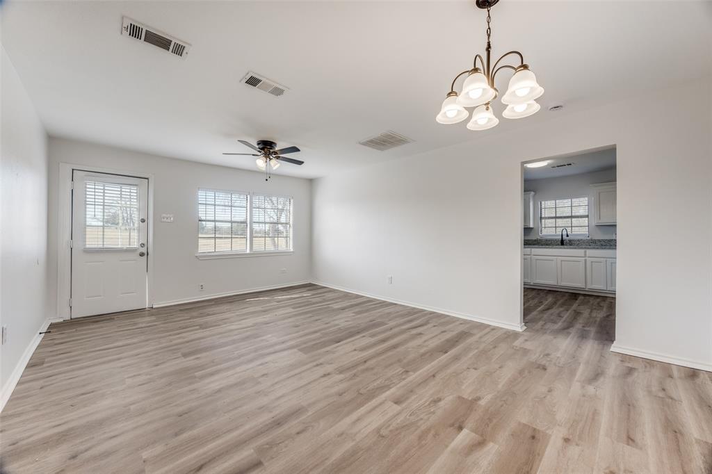 1382 Us Highway Denison, TX 75021 - Photo 5 of 25 a view of an empty room with a window and wooden floor