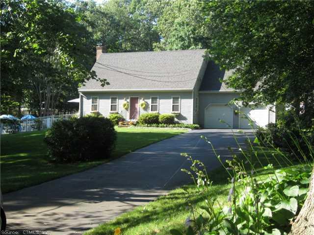 Exterior Front. Beautiful Cape sited on .66 acres with beautiful lawns and built in pool.