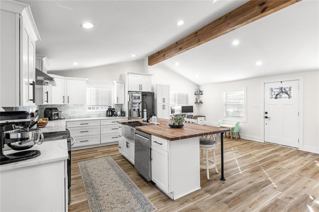 6120 Cardinal Drive Gainesville, GA 30506 - Photo 14 of 34 a kitchen with white cabinets and appliances