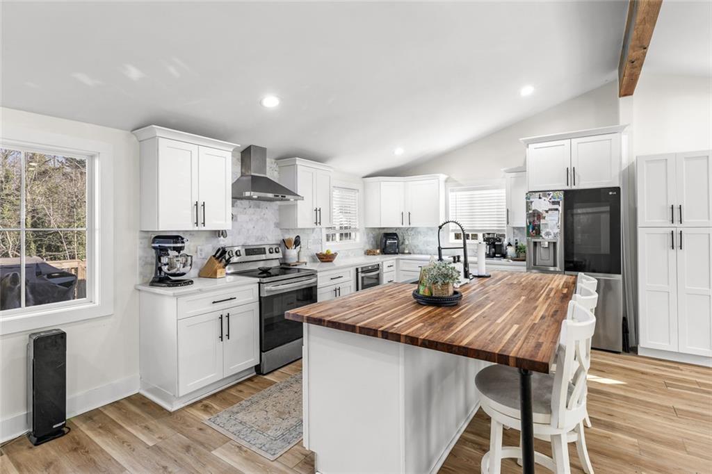6120 Cardinal Drive Gainesville, GA 30506 - Photo 15 of 34 a kitchen with granite countertop a refrigerator stove top oven and sink
