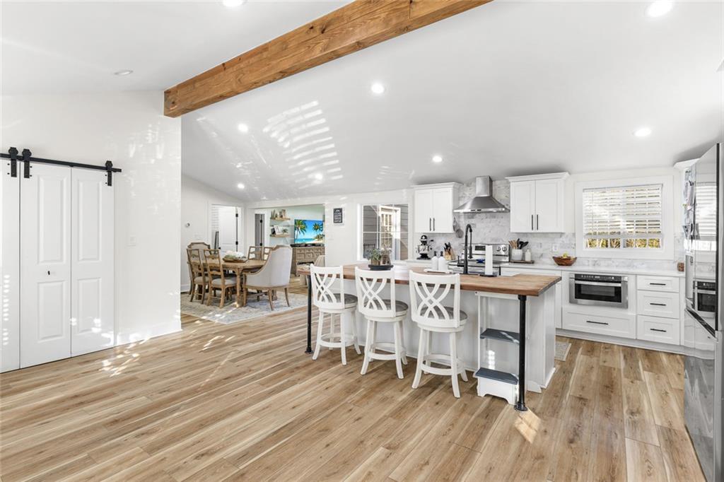 6120 Cardinal Drive Gainesville, GA 30506 - Photo 16 of 34 a dining room with furniture and wooden floor