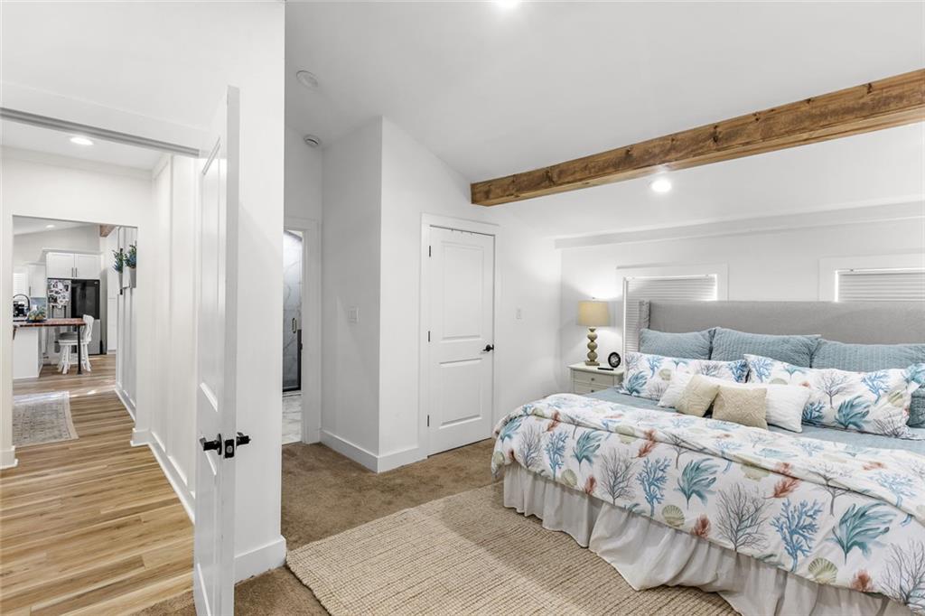 6120 Cardinal Drive Gainesville, GA 30506 - Photo 19 of 34 a bedroom with a bed and a wooden floor