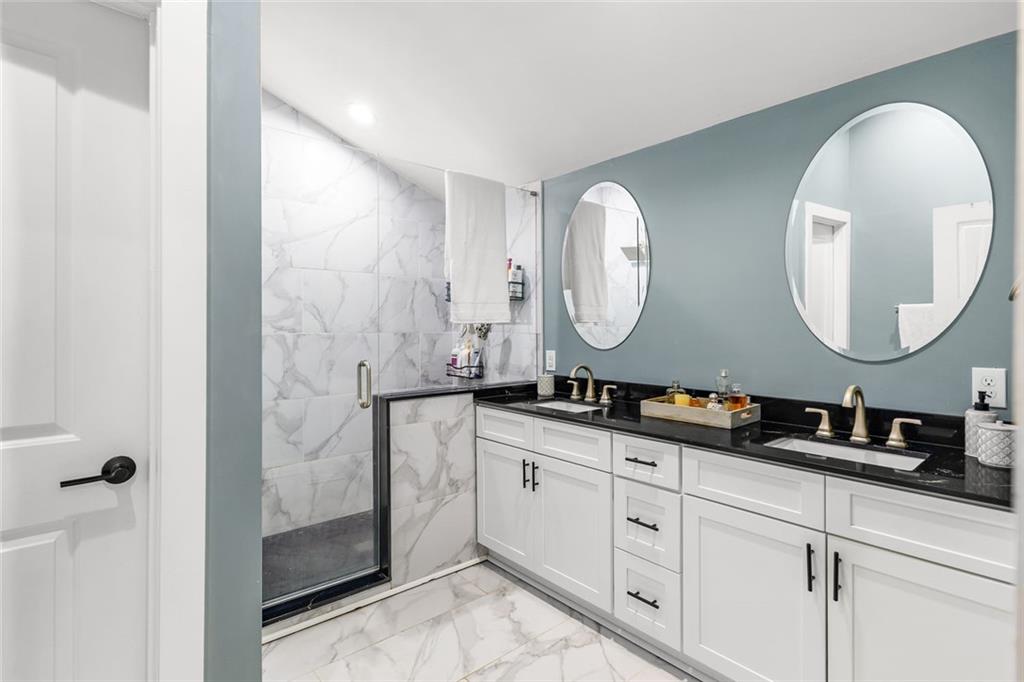 6120 Cardinal Drive Gainesville, GA 30506 - Photo 21 of 34 a bathroom with a double vanity sink and a mirror