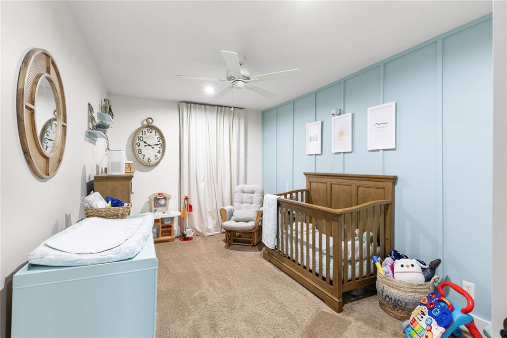 6120 Cardinal Drive Gainesville, GA 30506 - Photo 27 of 34 a bedroom with a baby bed a clock and a window