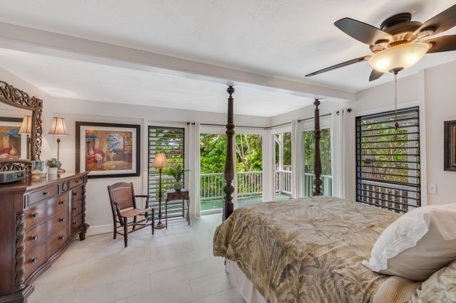 a bedroom with furniture and large windows