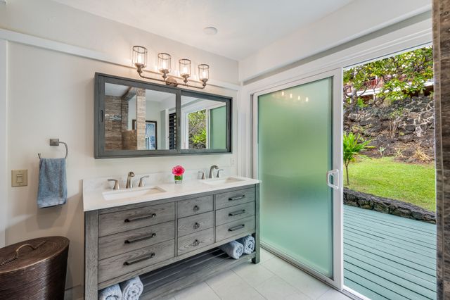 a bathroom with a double vanity sink and mirror