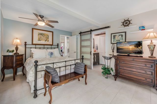 a bedroom with furniture and a chandelier
