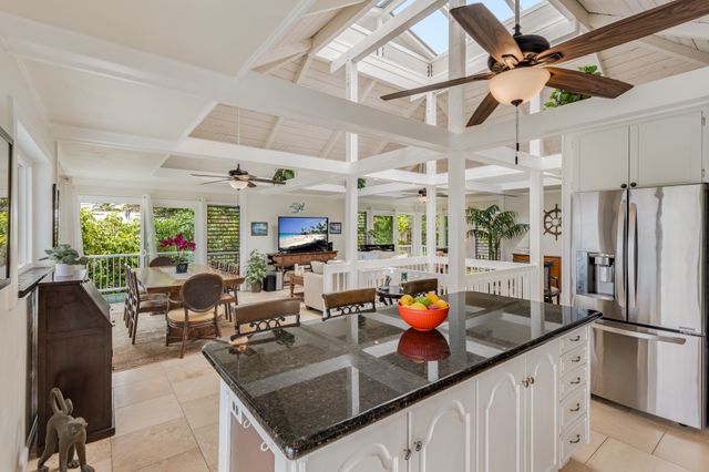 a kitchen with stainless steel appliances granite countertop a sink a stove and a refrigerator