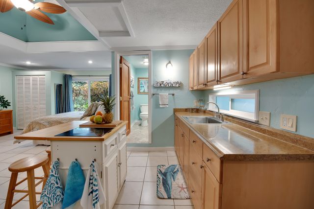 a kitchen with stainless steel appliances granite countertop a sink a stove and a wooden cabinets