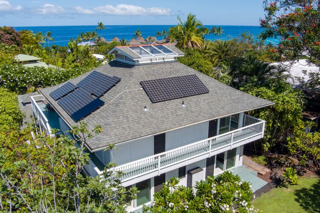 an aerial view of a house with a yard