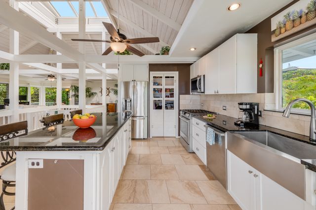 a kitchen with stainless steel appliances granite countertop lots of counter top space and a window