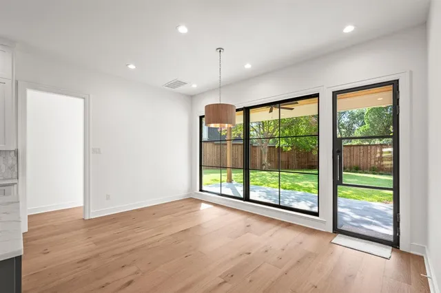 a large kitchen with kitchen island a sink stainless steel appliances and cabinets