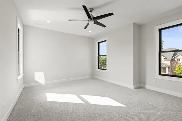 a view of a livingroom with a ceiling fan and window