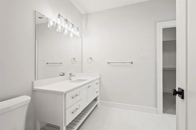 a bathroom with a shower sink and mirror