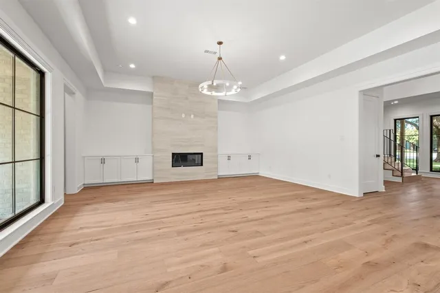 a view of staircase with lots of frames on wall and wooden floor