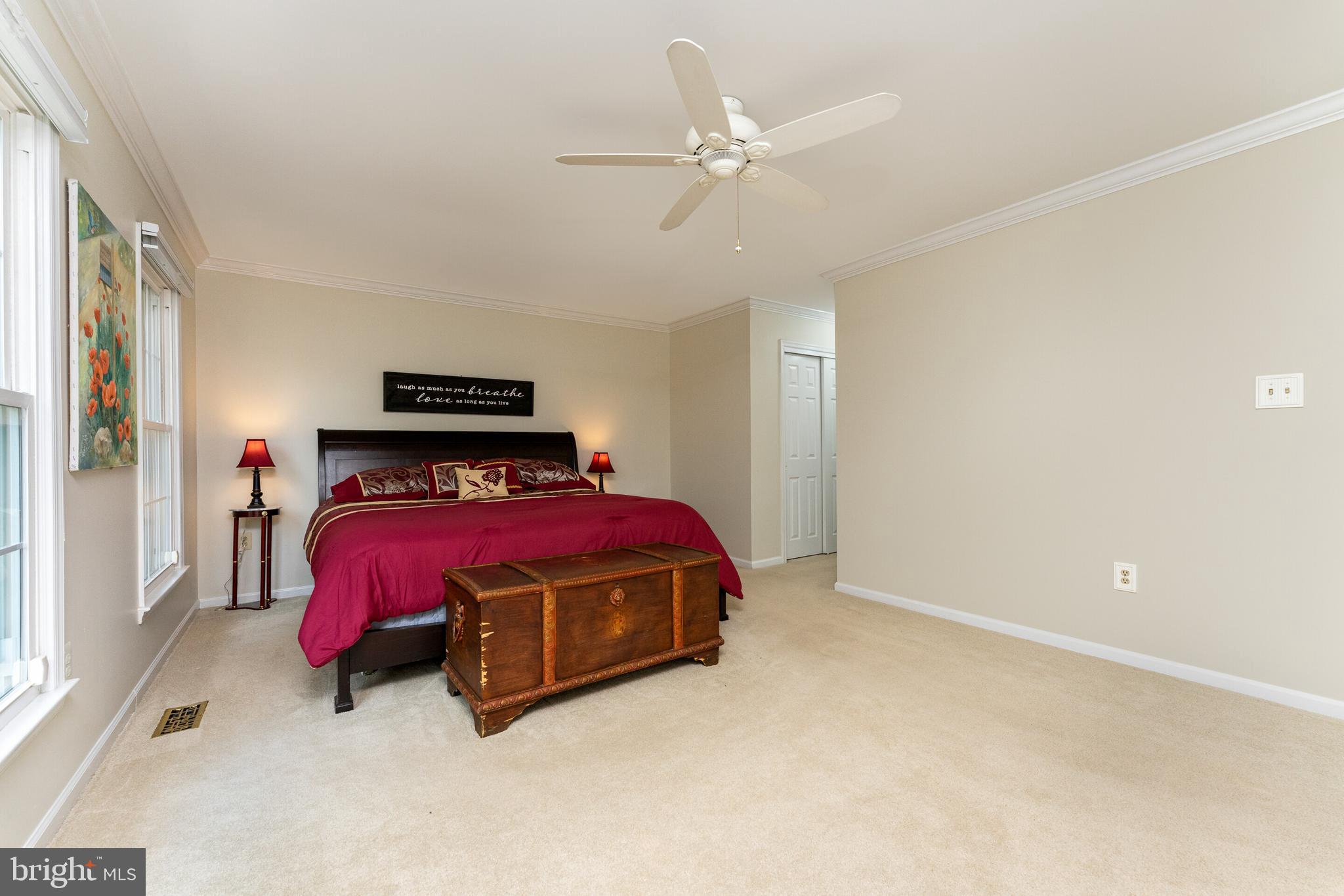 13824 Springstone Drive Clifton, VA 20124 - Photo 15 of 56 a bedroom with a bed and a chandelier