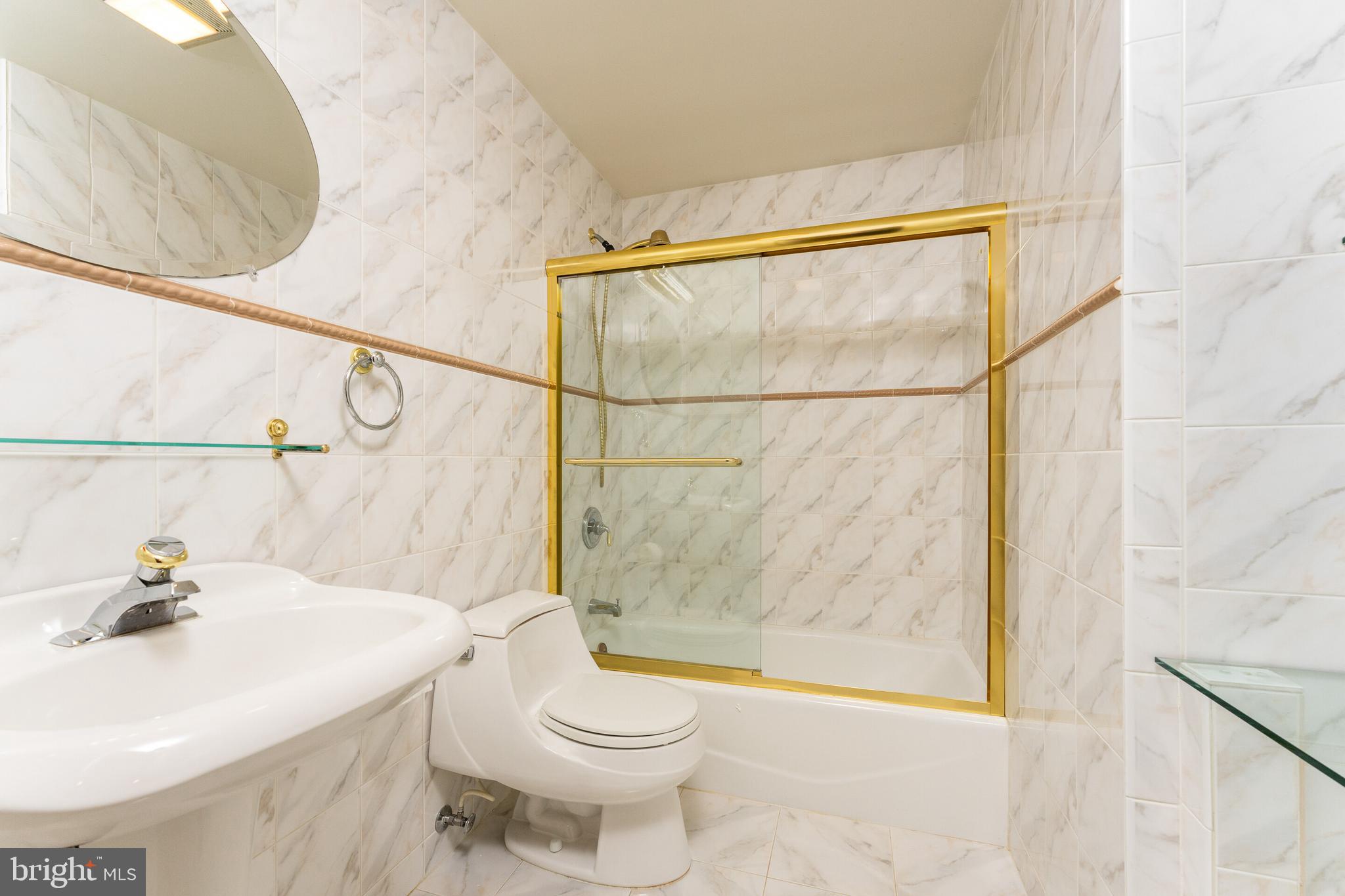 13824 Springstone Drive Clifton, VA 20124 - Photo 29 of 56 a bathroom with a sink a toilet and shower