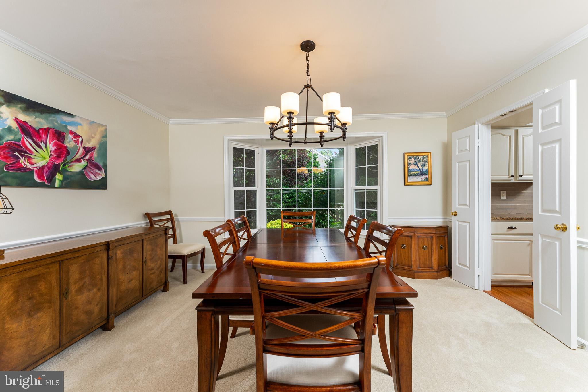 13824 Springstone Drive Clifton, VA 20124 - Photo 5 of 56 a dining room with furniture a chandelier and wooden floor