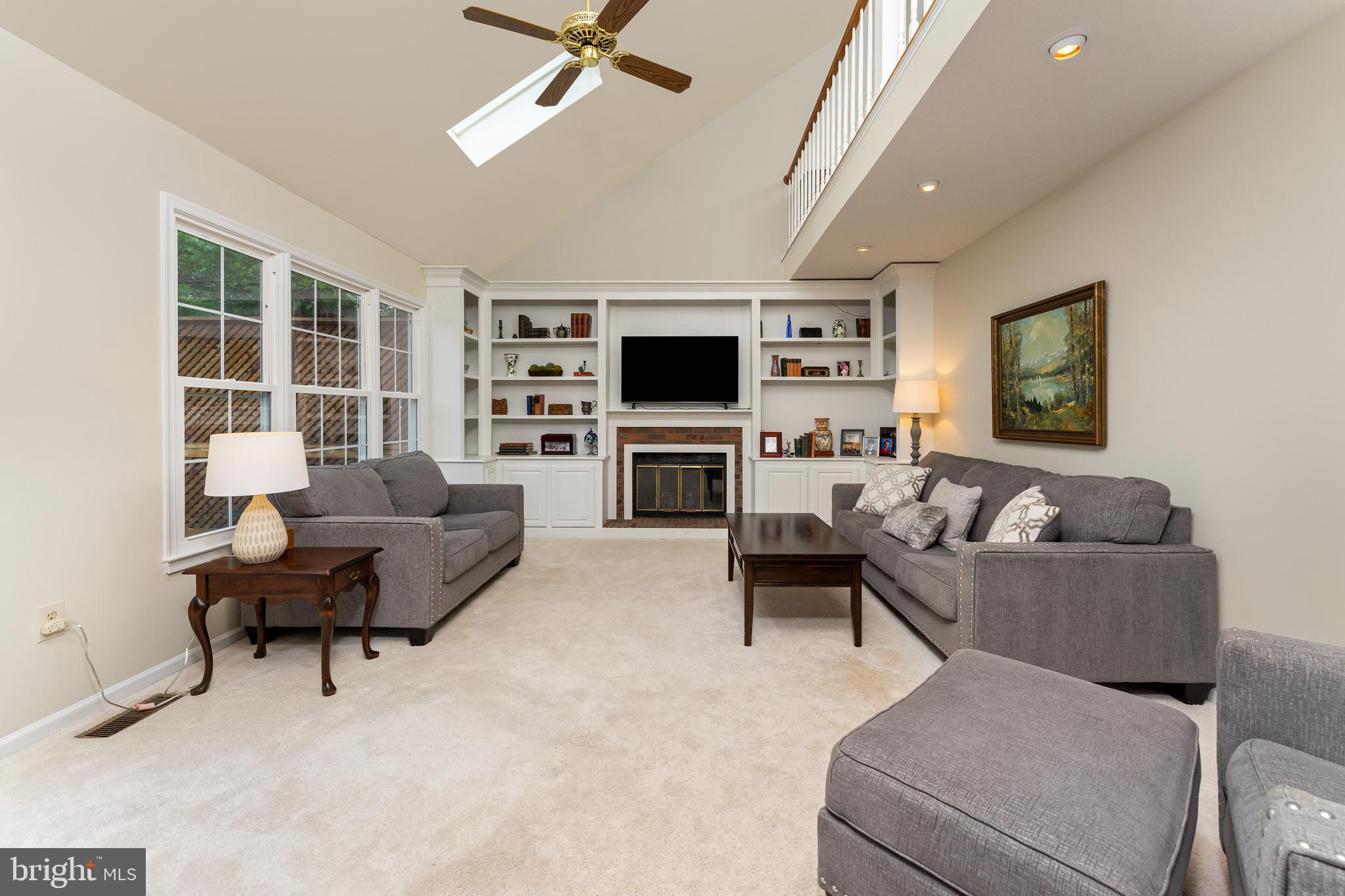 13824 Springstone Drive Clifton, VA 20124 - Photo 9 of 56 a living room with furniture a flat screen tv and a fireplace