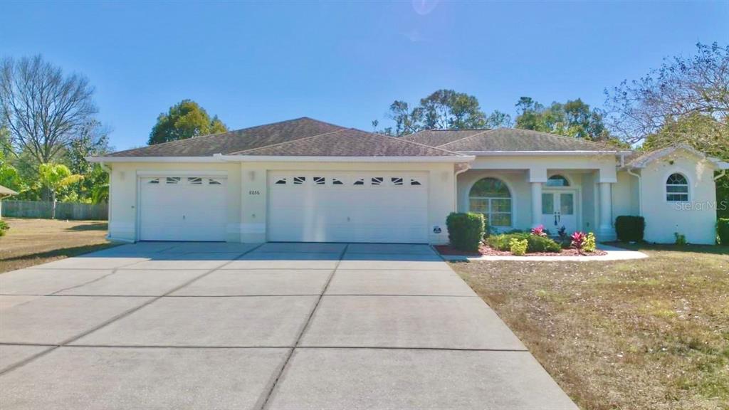 a view of a house with potted plants