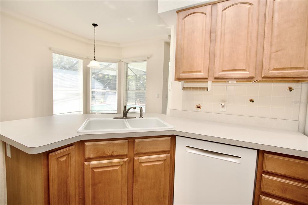 8056 Floral Drive Spring Hill, FL 34607 - Photo 13 of 29 a kitchen with stainless steel appliances granite countertop a sink and a window