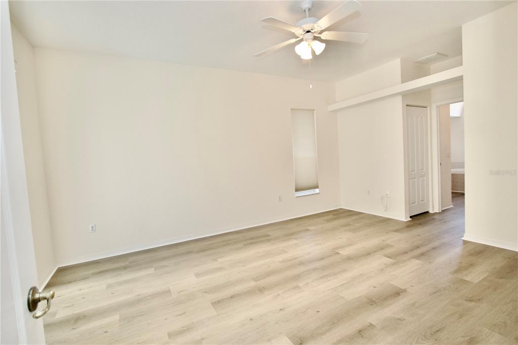 8056 Floral Drive Spring Hill, FL 34607 - Photo 16 of 29 an empty room with a ceiling fan and a window