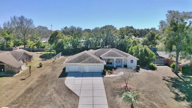 a view of a house with a yard and sitting area