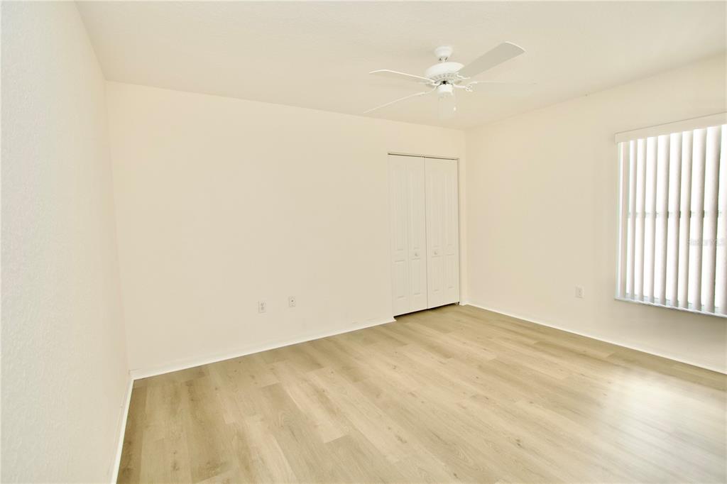 8056 Floral Drive Spring Hill, FL 34607 - Photo 21 of 29 an empty room with a window and a ceiling fan