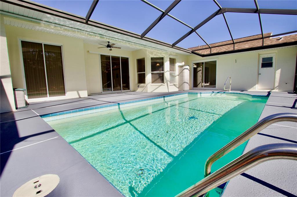 8056 Floral Drive Spring Hill, FL 34607 - Photo 25 of 29 a view of a patio with a table and chairs