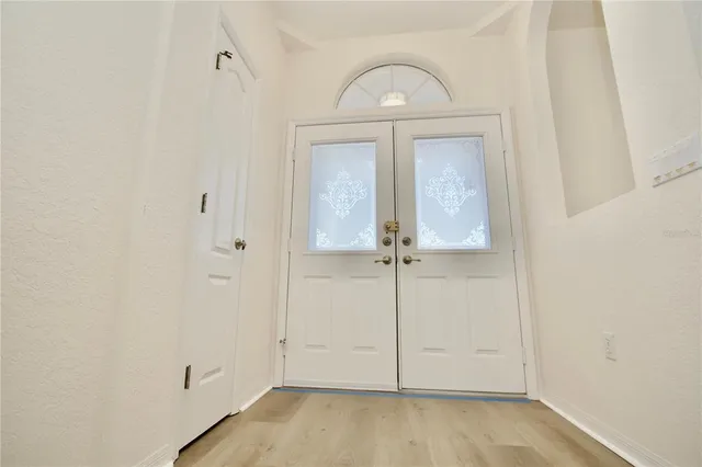 an empty room with wooden floor cabinet and closet