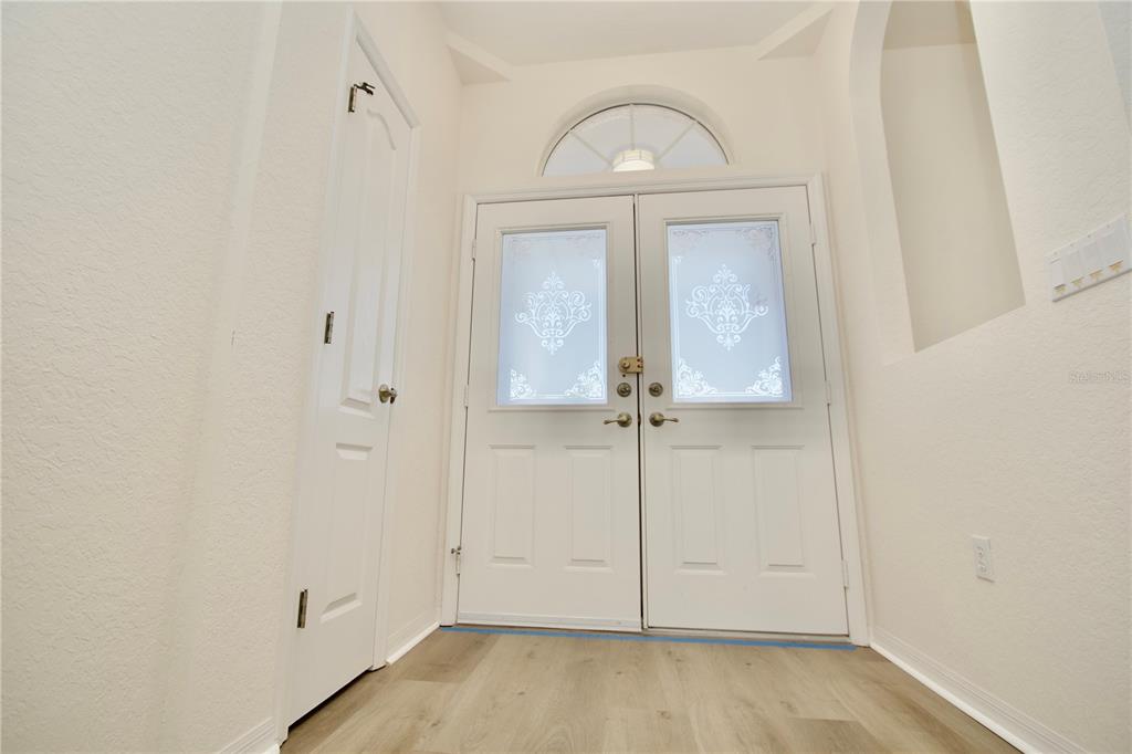 8056 Floral Drive Spring Hill, FL 34607 - Photo 9 of 29 an empty room with wooden floor cabinet and closet