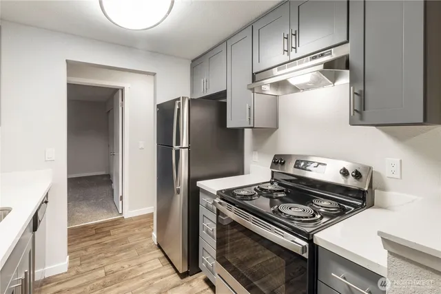 a kitchen with a stove and a refrigerator