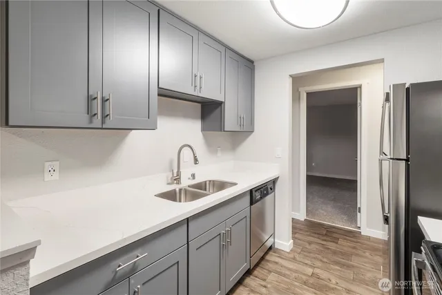 a kitchen with a sink and a refrigerator