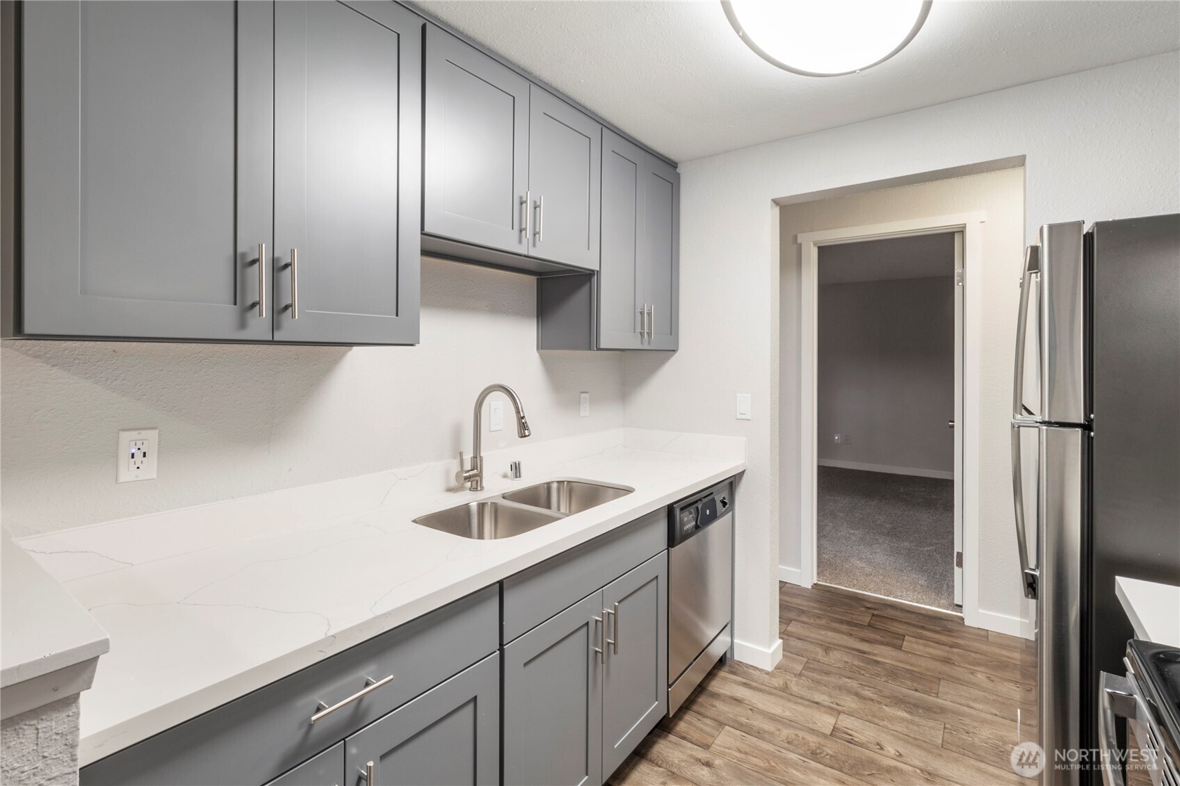 34007 1st Circle South Federal Way, WA 98003 - Photo 9 of 13 a kitchen with a sink and a refrigerator