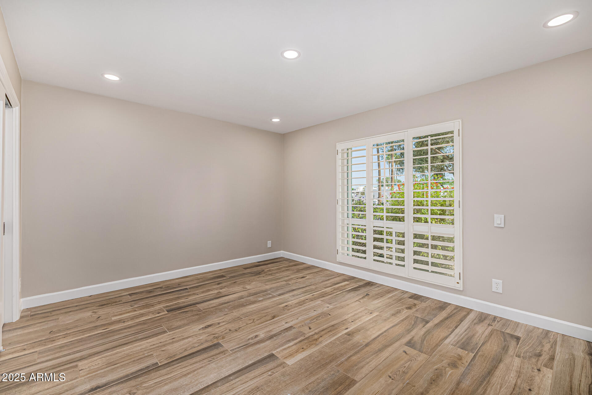 19 East Boca Raton Road Phoenix, AZ 85022 - Photo 43 of 54 an empty room with wooden floor and windows
