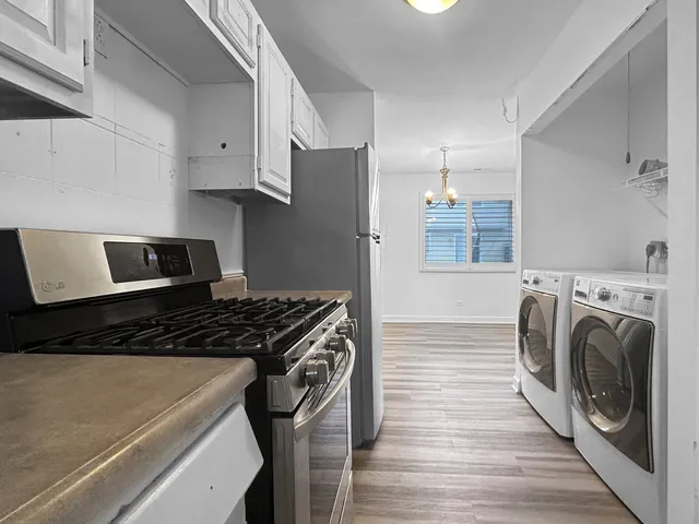 a kitchen with granite countertop a stove and a refrigerator