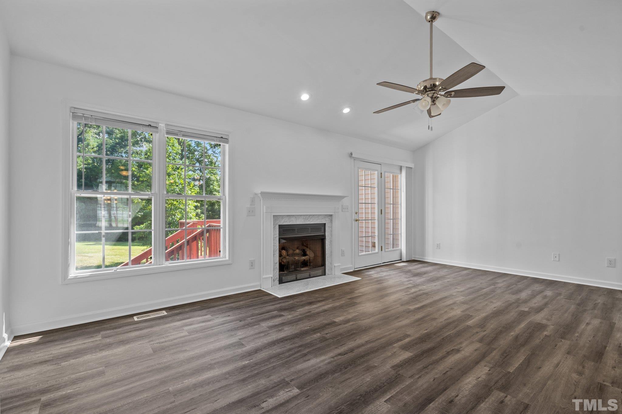 302 Laurel Drive Smithfield, NC 27577 - Photo 14 of 38 a view of an empty room with a window and fireplace