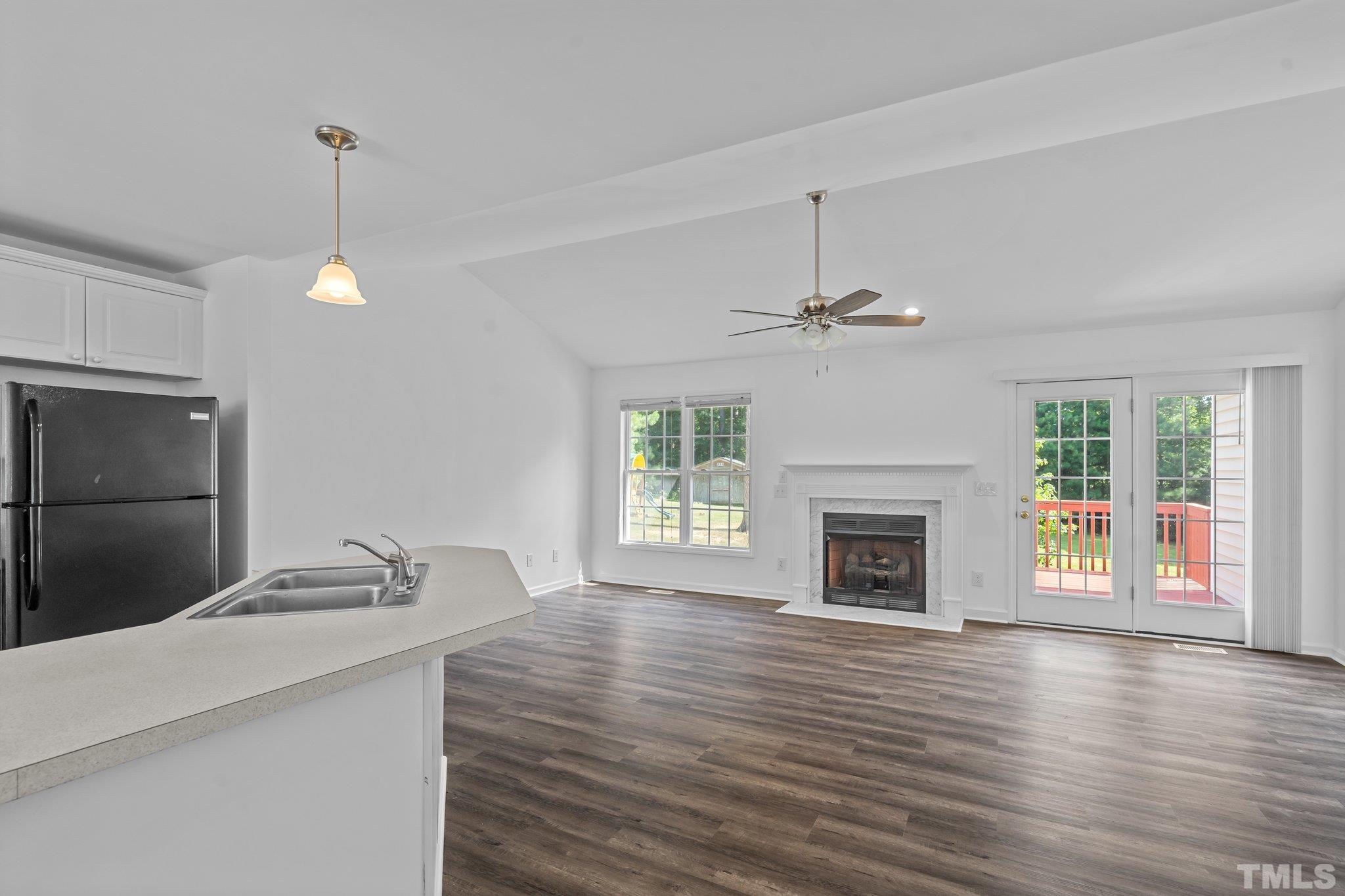 302 Laurel Drive Smithfield, NC 27577 - Photo 17 of 38 a living room with fireplace and wooden floor